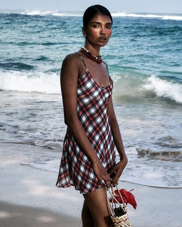Model in a plaid slip dress at the water’s edge